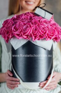 Hatbox filled with roses. You can create a lovely romantic design by arranging roses in a hatbox. Pink roses have been used in this design